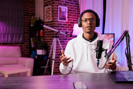 Content creator broadcasting live on streaming platform from vibrant neon lights home studio using...
