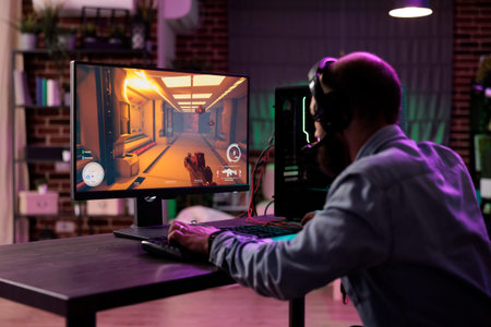Pro gamer competing in intense online multiplayer videogame, broadcasting competition live from...