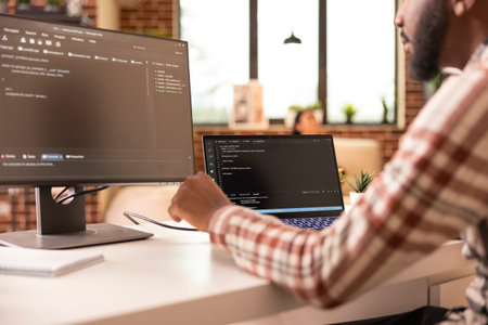 African american tech freelancer programming secure systems and reviewing coding scripts in...