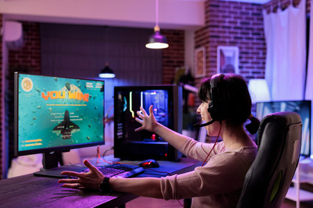 Gamer girl ecstatic about winning singleplayer flying game mission. Woman seeing winner message on...