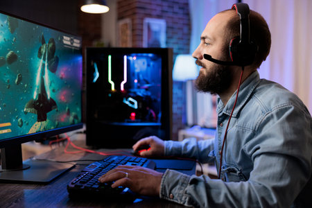 Gamer playing classic arcade space shooter videogame, shooting asteroid using lazer beams. Man...