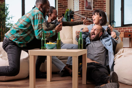 Multiethnic group of friends celebrating video games win at gathering, having fun together and...