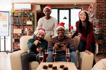 Startup diverse employees team enjoying festive christmas celebration in office. Colleagues drinking...