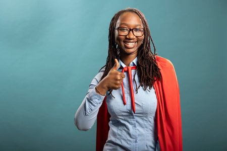 African american female individual posing with an approval finger gesture. Smiling black woman in...