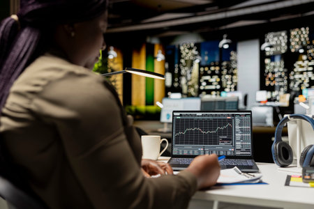 African american staff monitoring live stock trends for cryptocurrency market, leveraging technology...