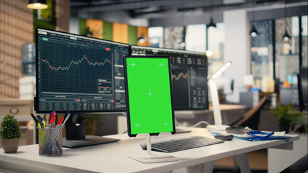 Close up of isolated screen tablet displaying stock market graphs in proprietary firm office. Mockup...