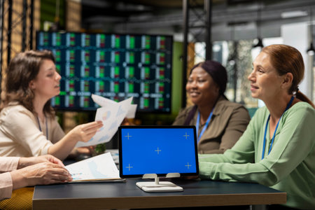 Coworkers attending a briefing meeting session with isolated display on tablet, session for...