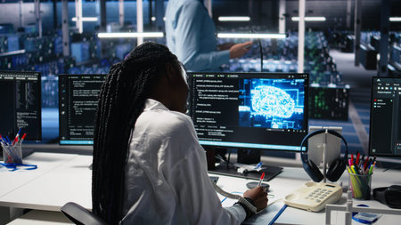 Female technician in data center answers telephone call, assisting users with AI troubleshooting....