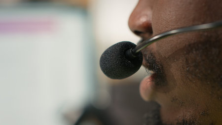 Male call center clerk assisting a person with order mix up problems, verifying parcel status on...