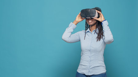 Portrait of woman using vr glasses on camera, working with virtual reality headset and playing with...