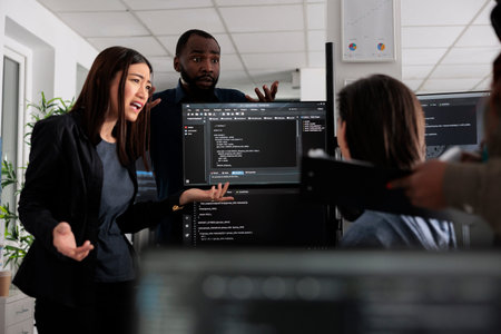Diverse web developers collaborating about programming project talking about coding algorithm for...
