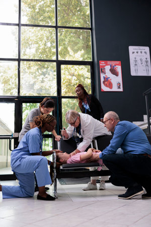 Scared family after unconscious little child falling down on chair in hospital waiting room during...