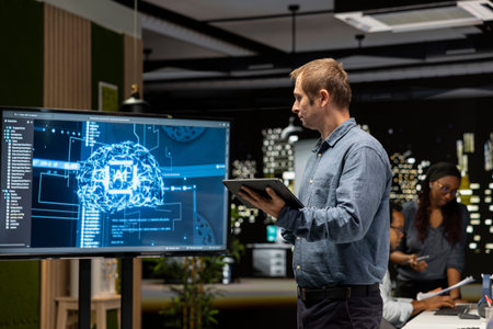 System administrator machine learning APIs developed by interns. Tech company team leader looking at...