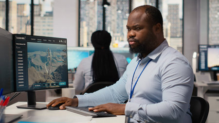 Engineer in office working on power lines pole CAD design to develop technology improving...