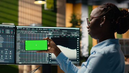 Prop firm intern in office learns new trading strategies from video lesson on green screen mobile...
