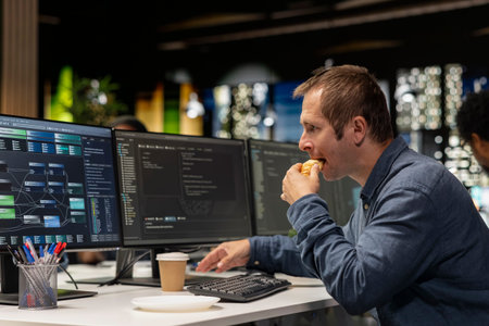 Software developer eating croissant in office, reviewing AI system metrics, monitoring performance...