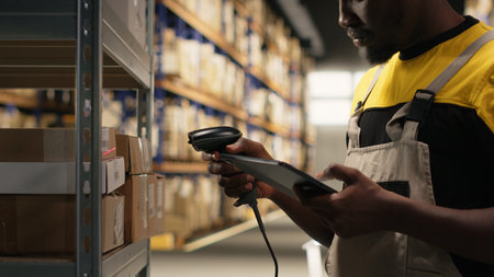 African american man using scanner to register barcodes tags in inventory, solving logistics...