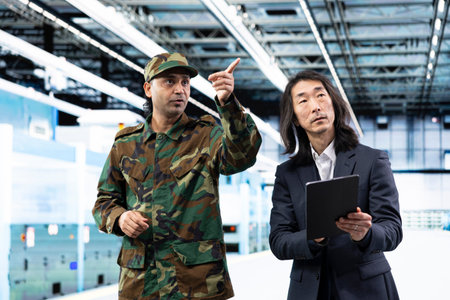 Military man and senior manager manufacturing semiconductors to win chip war, using tablet....