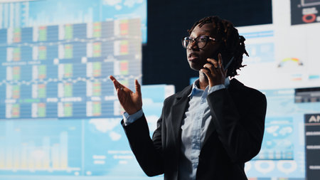 Manager doing telephone call with shareholders, talking about business market graphs, doing...