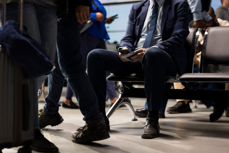 Using phone, business trip and businessman in airport looking at plane departure timetable. Doing travel destination itinerary, smartphone close up and digital nomad going to conferences