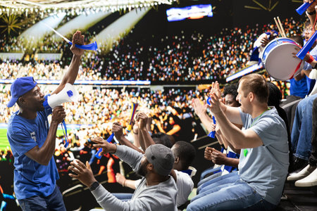 Blue team football capo standing above crowd with megaphone, leading passionate supporter section during energetic stadium chant. Organized fans producing powerful support chants.
