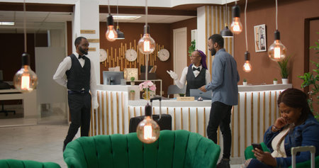 Traveller receiving room key card at reception front desk, bellboy providing concierge services and helping client with suitcase, man client enjoying five star hotel ammenities, tourism.