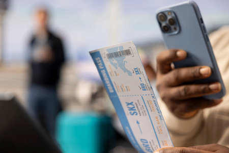 Scanning boarding pass code, close up, black guy with flexible career, work anywhere concept of a digital nomad. Remote worker with location independent lifestyle and mobility freedom.