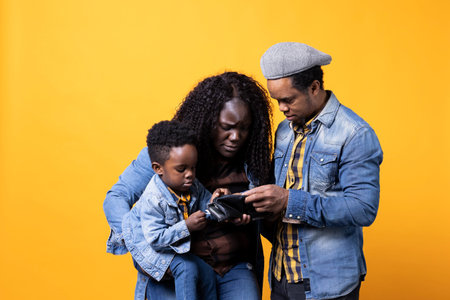 African American parents in debt struggling with money and expenses for childcare, looking for ways to increase family income and savings, mom and dad being worried about financial difficulties.