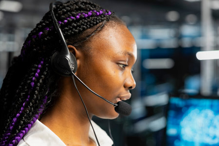 Engineer wears a headset in a server room, using artificial intelligence troubleshooting to assist users.