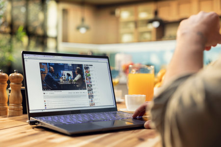 Casual person, online video content, streaming platform on laptop, watching podcast discussion, user generated online entertainment, free to watch, everyday life with leisure indoors.