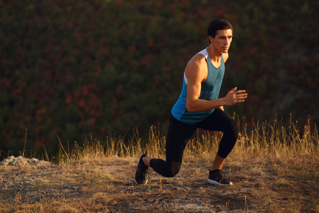 Athletic, muscular, fit, young man wearing in a sportswear, runner outside, isoalted on a sunset...