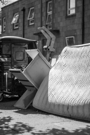 A mattress and furniture on the streetの写真素材