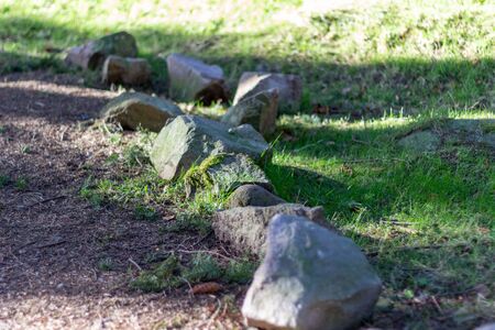 Line of stones next to the path in Tyrebagger Woodsの写真素材