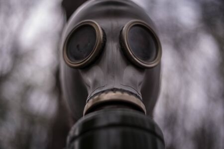 Close up of a man wearing a gas mask, in the forestの写真素材