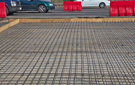 Renewal of the asphalt paving on the road  metal grid on the concrete basement