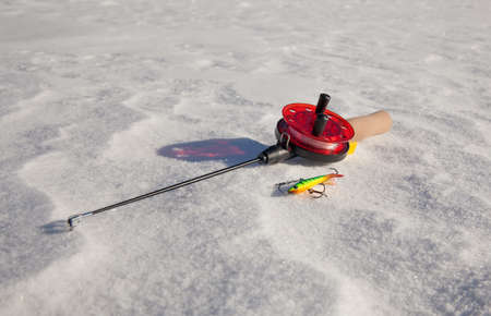 Ice fishing rod with the lure on the snowの写真素材