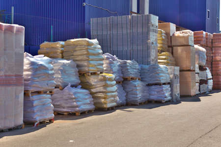 Construction materials stacked near the warehouseの写真素材