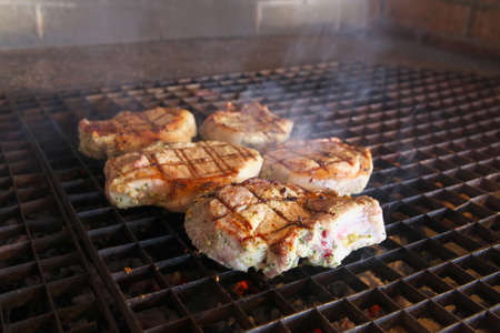 Steaks being cooked on the grillの写真素材