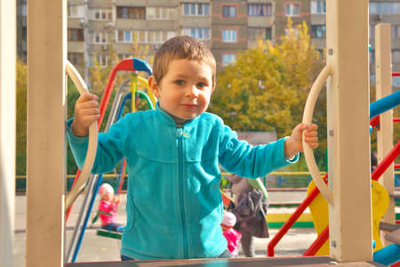 Little boy having fun on playgroundの写真素材