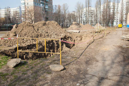 Hot water pipes breakage - open pit for repairingの写真素材