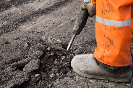 Man repairing the road with a pneumatic hammerの写真素材
