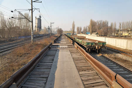 Empty railway cargo platforms standing near the factory areaの写真素材