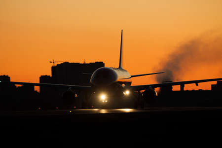Jet on the runway at sunrise or sunset