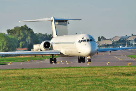 White passenger jet taxiing to the runway in the airportの写真素材