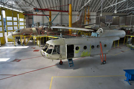 Helicopter and plane in the assembly shop at the maintenance facility