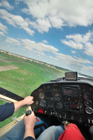 Two men flying a small private aircraft - view from the cockpit