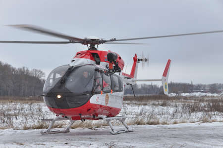 Nezhin, Ukraine - January 14, 2011: Ukrainian Ministry of Emergency Situations Eurocopter EC145 (BK-117) rescue helicopter taking off from the fieldのeditorial素材