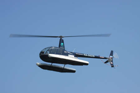Gelendzhik, Russia - September 9, 2010: Robinson R44 helicopter with floats preparing to land on waterのeditorial素材