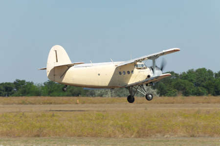 Old biplane takeoff from the rough airstrip