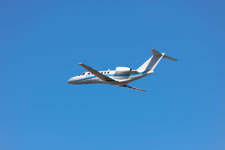 Private business jet has just taken off into the blue morning sky
